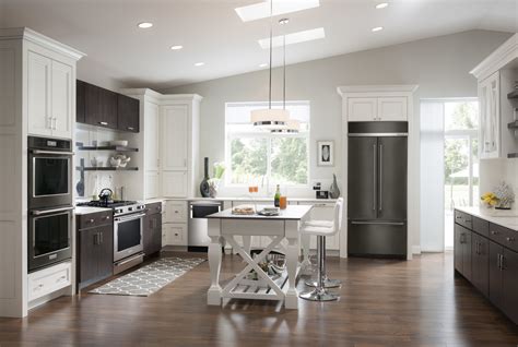 kitchen cabinets with black stainlesd steel appliances and light floors|kitchens with black fridge.